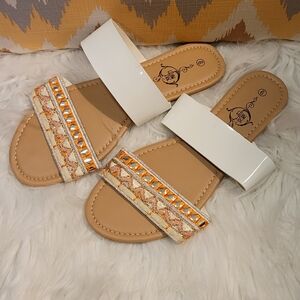 Elegant White and Tan Sandals with Orange Accents